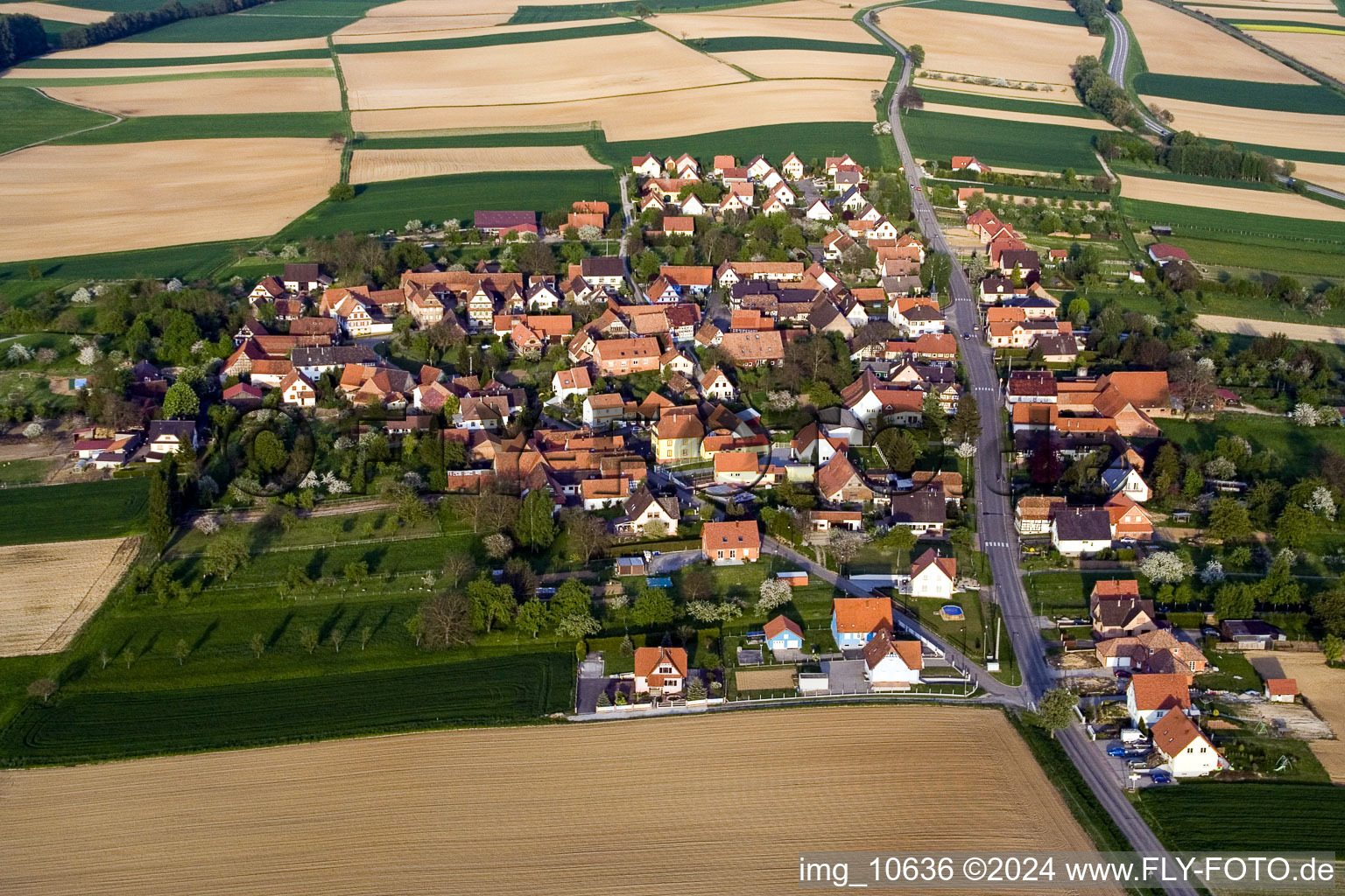 Aerial photograpy of Village - view on the edge of agricultural fields and farmland in Hoffen in Grand Est, France