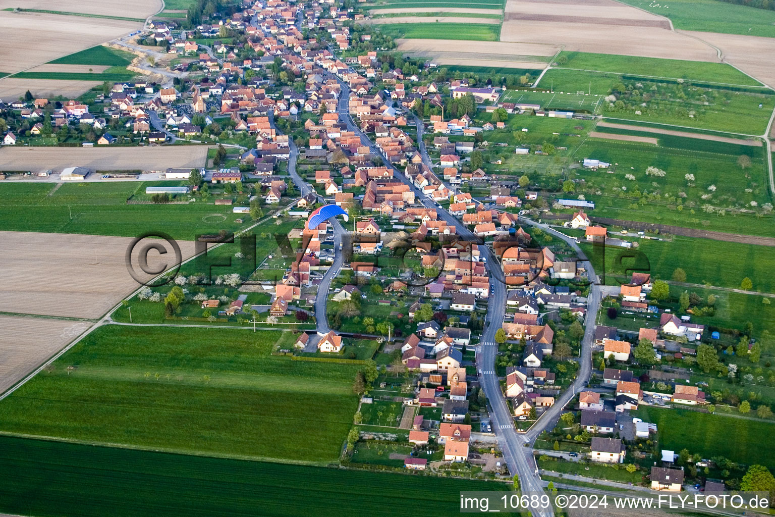 Village - view on the edge of agricultural fields and farmland in Eschbach in Grand Est, France