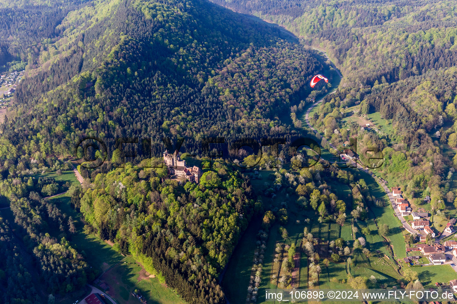 Castle of the fortress Burg Berwartstein with mit Paraglider in Erlenbach bei Dahn in the state Rhineland-Palatinate, Germany