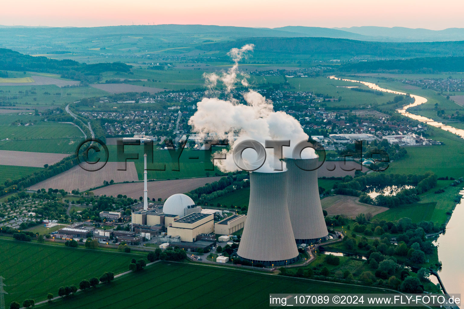 Aerial view of Building remains of the reactor units and facilities of the NPP nuclear power plant Grohnde on the river Weser during sunset in Grohnde in the state Lower Saxony, Germany