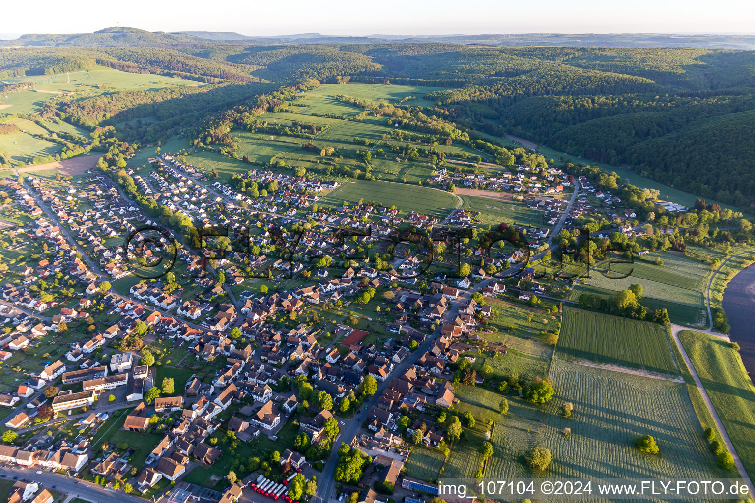 Location view of the streets and houses of residential areas in the valley landscape surrounded by mountains in Stahle in the state North Rhine-Westphalia, Germany