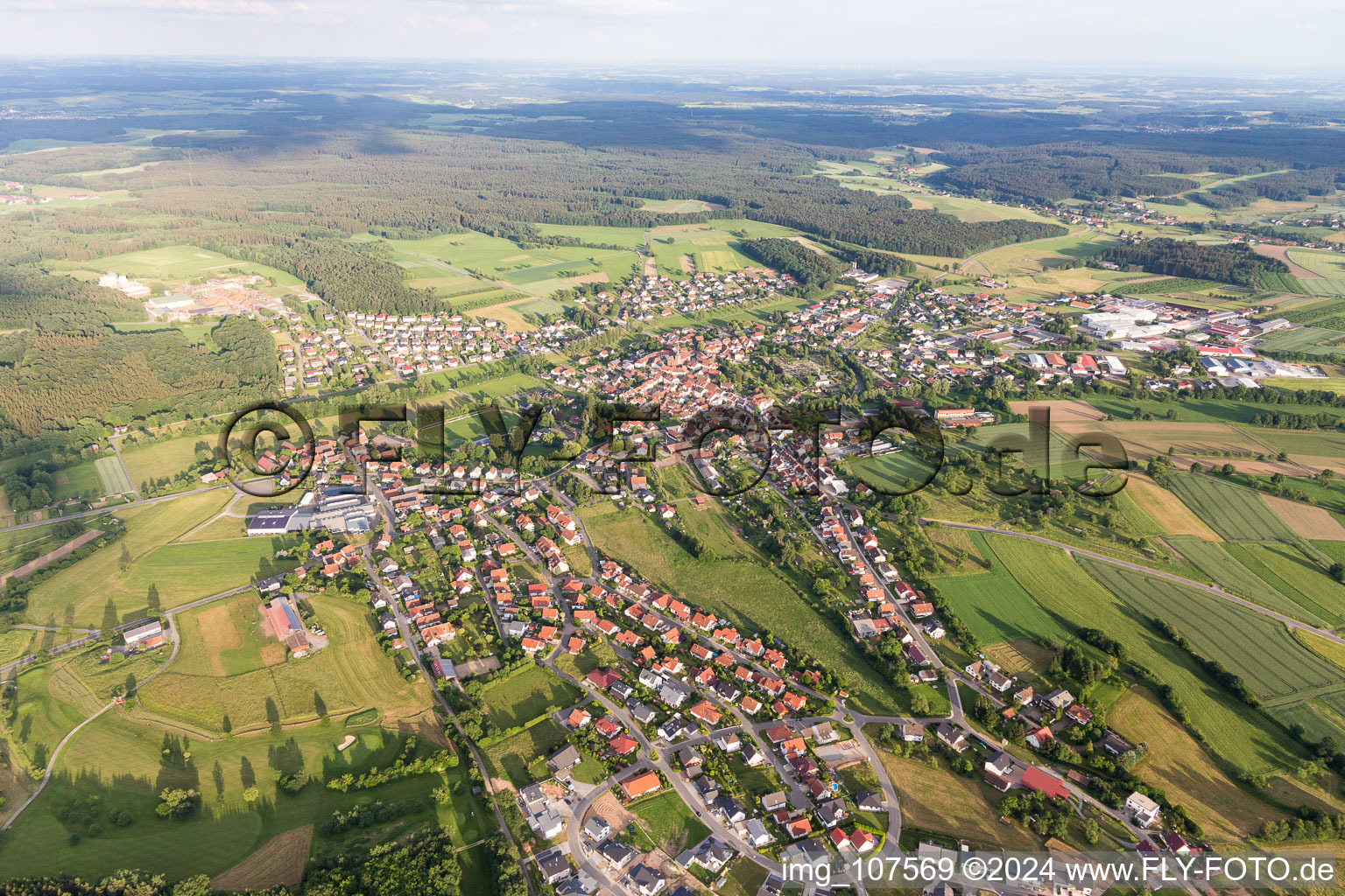 Aerial view of Village view on the edge of agricultural fields and land in Mudau in the state Baden-Wurttemberg, Germany