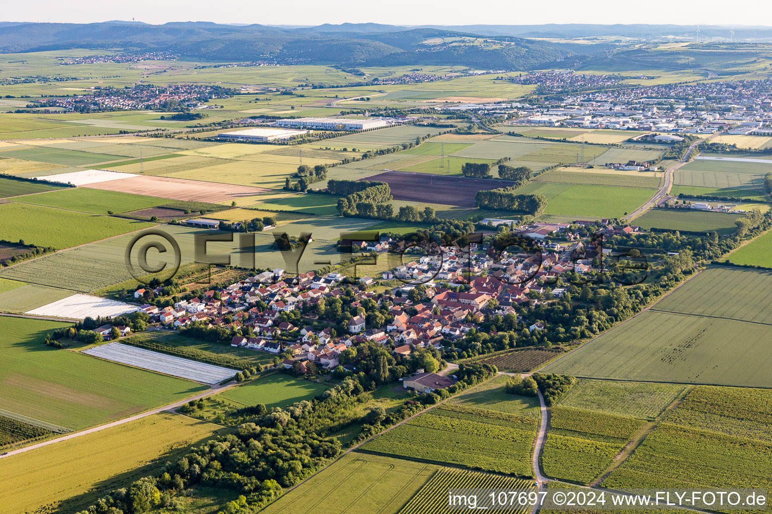 Aerial view of Agricultural land and field borders surround the settlement area of the village in Obersuelzen in the state Rhineland-Palatinate, Germany
