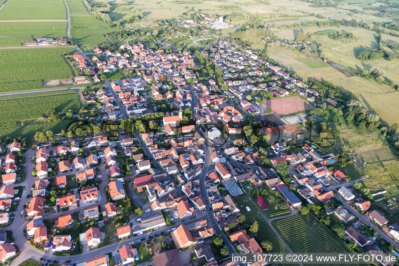 Agricultural land and field borders surround the settlement area of the village in Erpolzheim in the state Rhineland-Palatinate, Germany out of the air