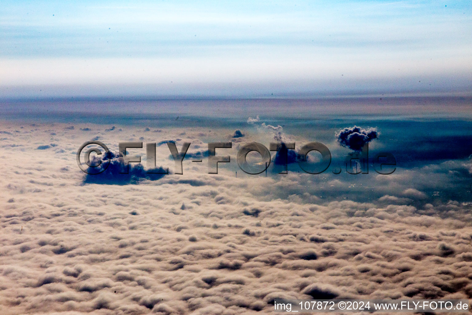 Clouds of smoke of over the power plant of ENBW over clouds-covererd Rhine valley in Karlsruhe in the state Baden-Wurttemberg, Germany