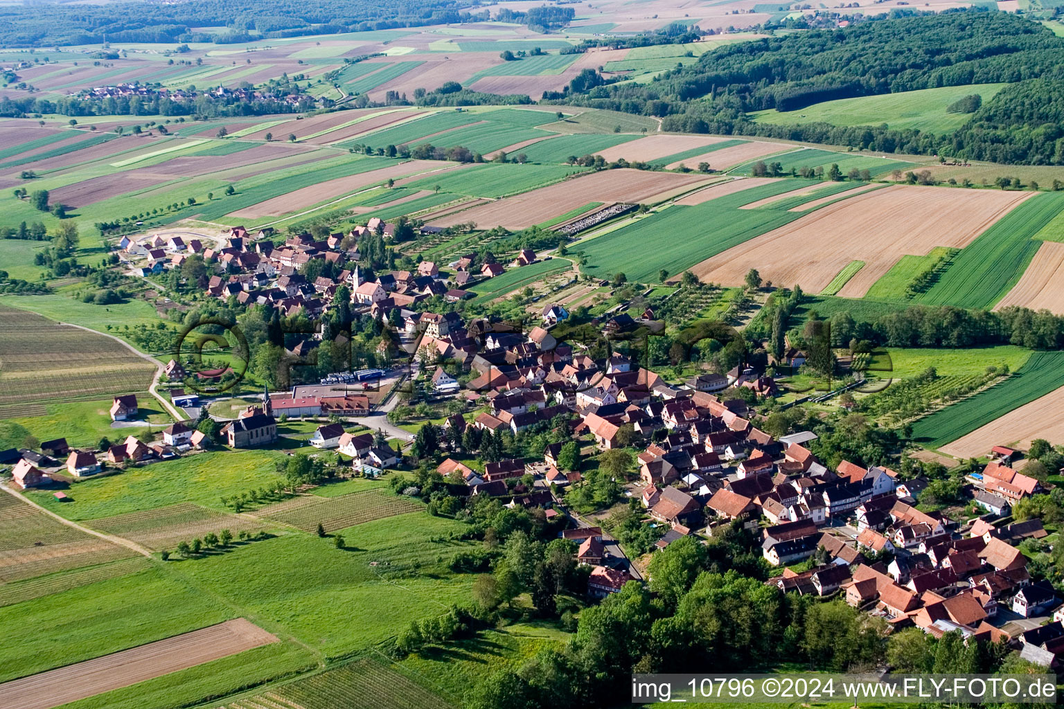 Village - view on the edge of agricultural fields and farmland in Cleebourg in Grand Est, France