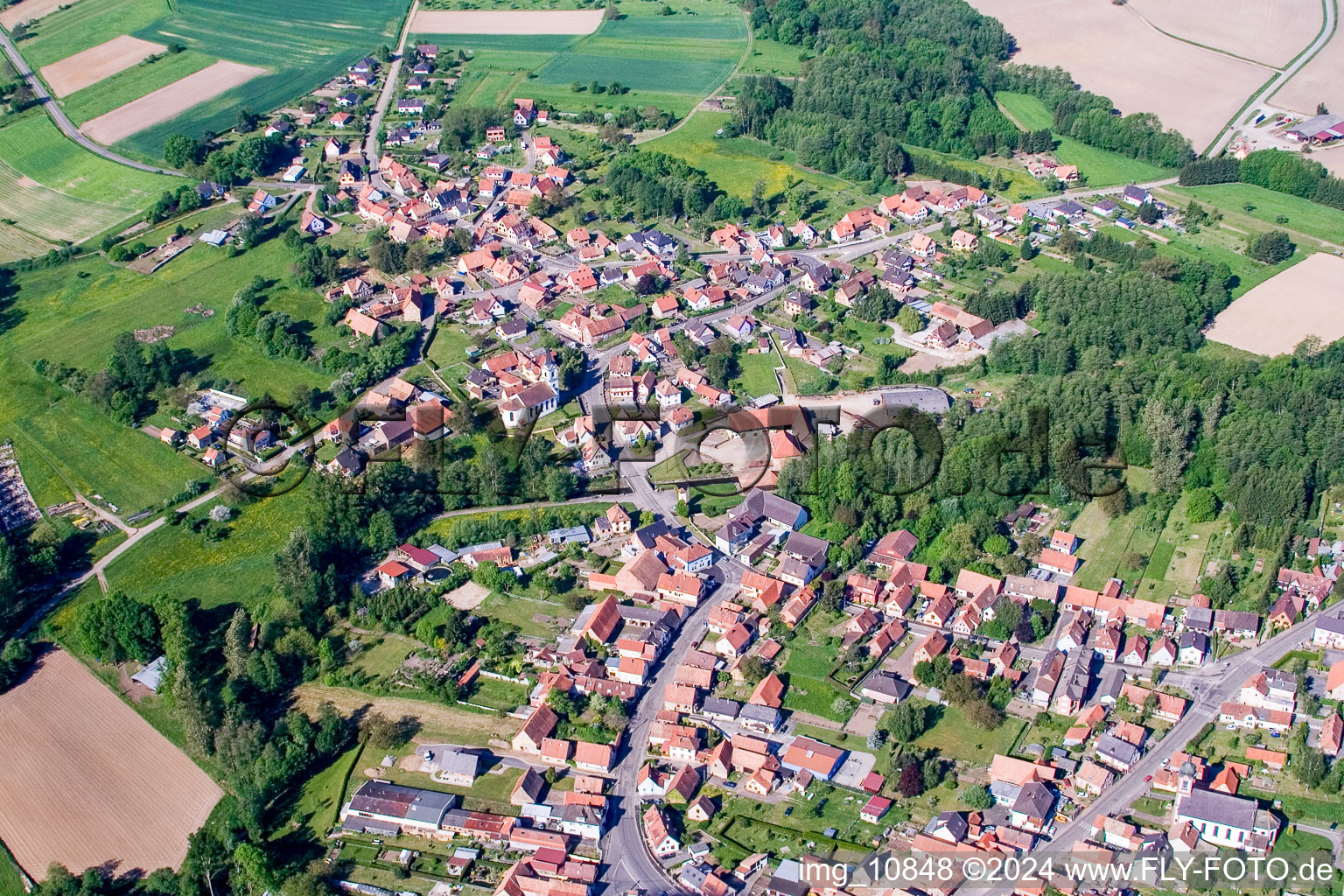 Aerial view of Village - view on the edge of agricultural fields and farmland in Gumbrechtshoffen in Grand Est, France