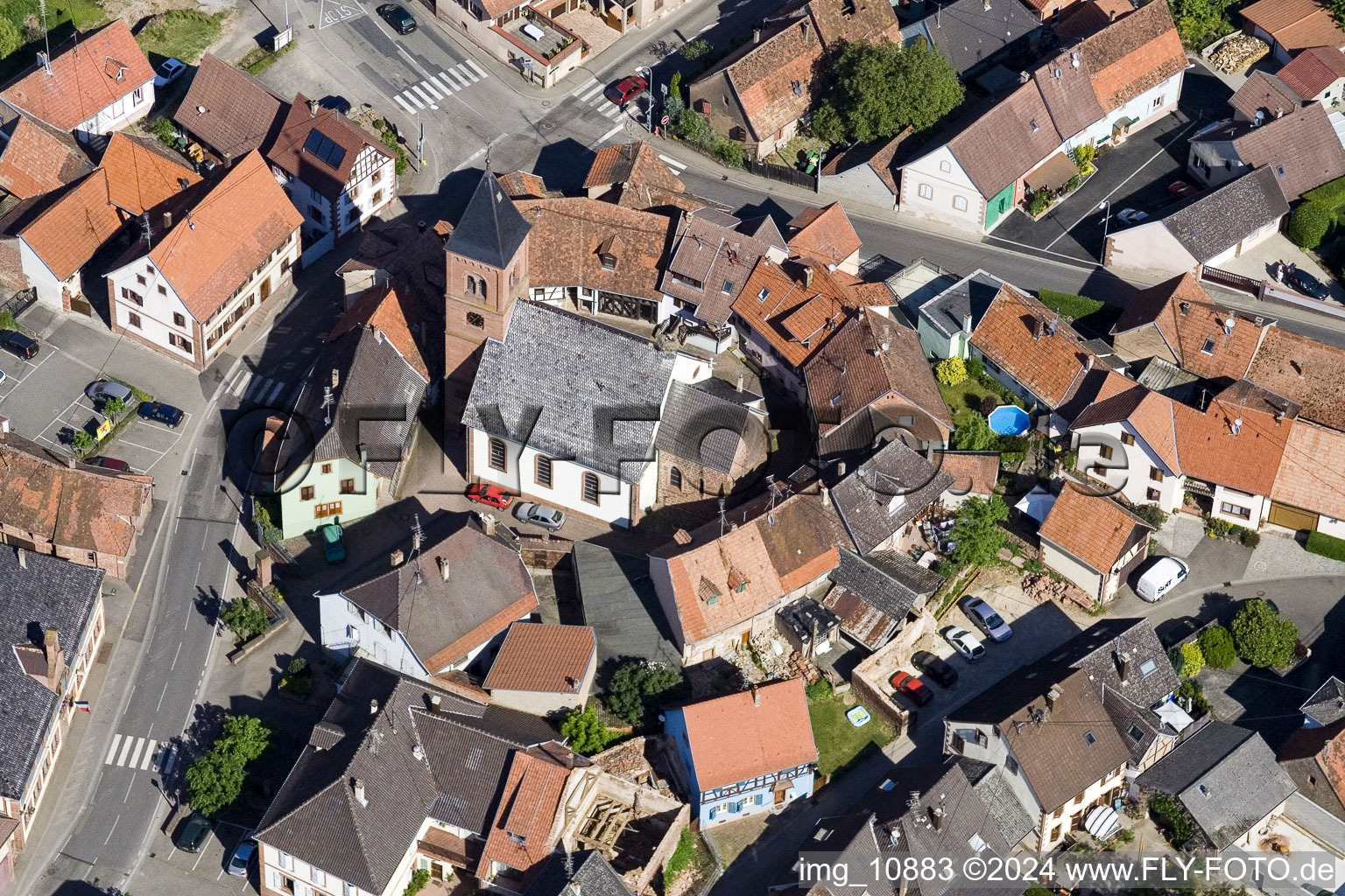 Protestantic Church building in the center of a circle of houses in the village of in Dossenheim-sur-Zinsel in Grand Est, France