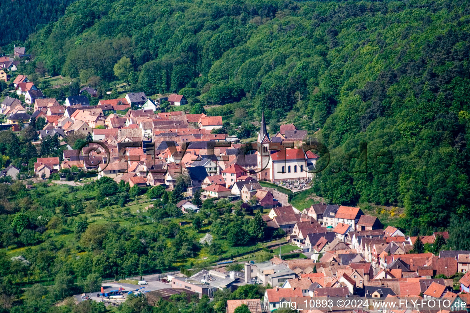 Aerial view of Village - view on the edge of agricultural fields and farmland in Saint-Jean-Saverne in Grand Est, France