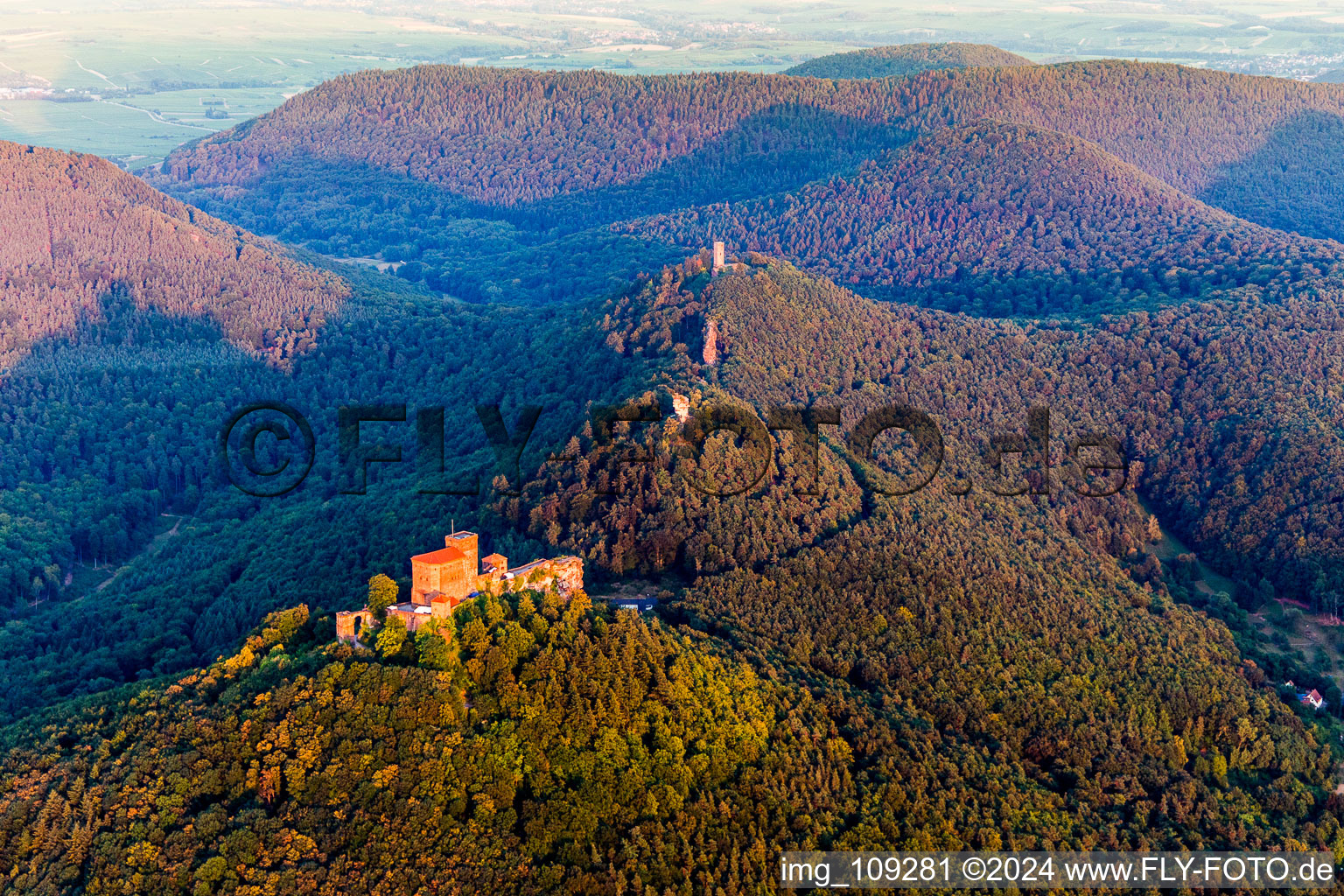 Castle of Trifels and the former fortresses Anebos and Scharfenberg(Muenz) in morning light above the hills of the Pfaelzerwald in Annweiler am Trifels in the state Rhineland-Palatinate, Germany