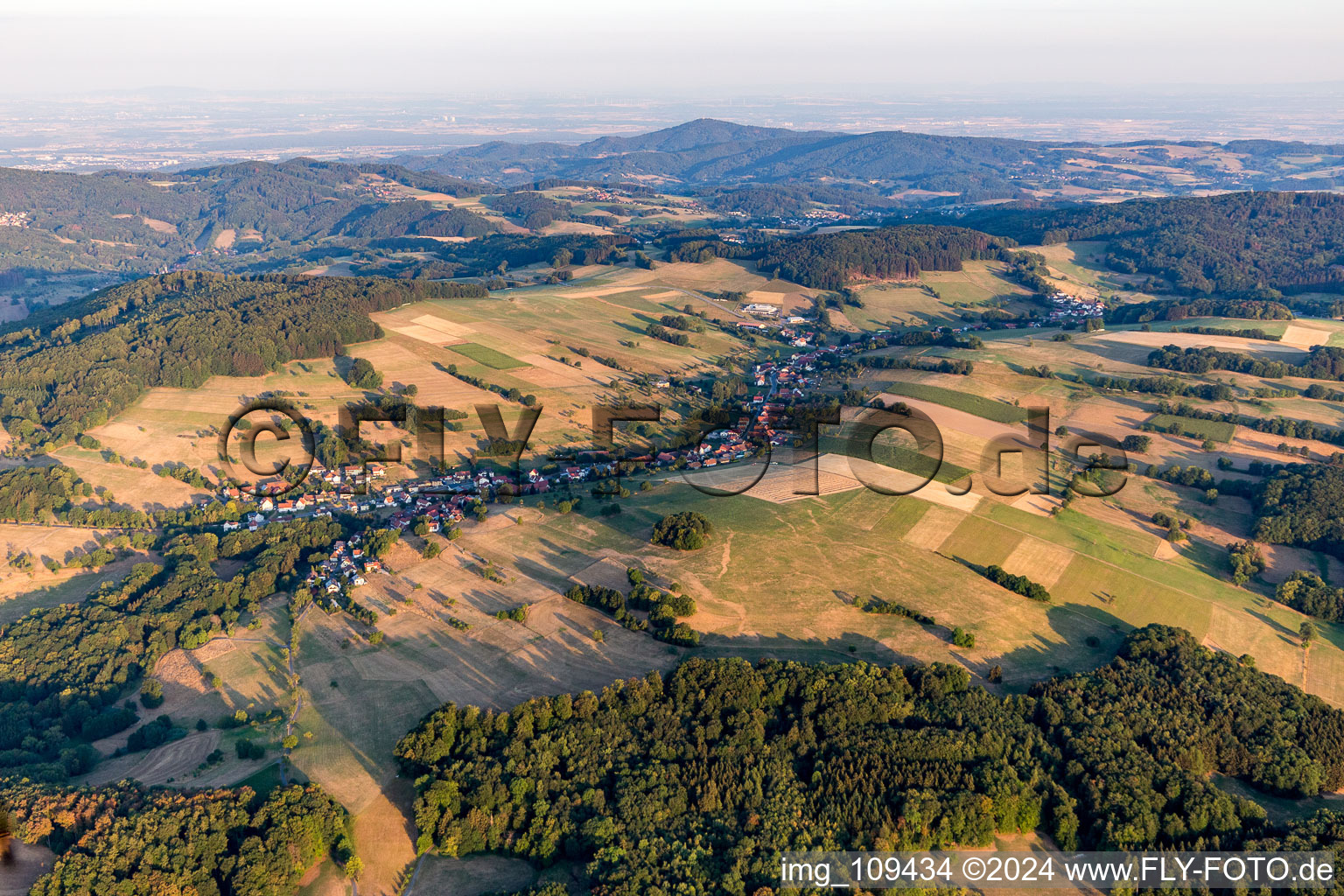 Agricultural land and field borders surround the settlement area of the village in Gumpen in the state Hesse, Germany