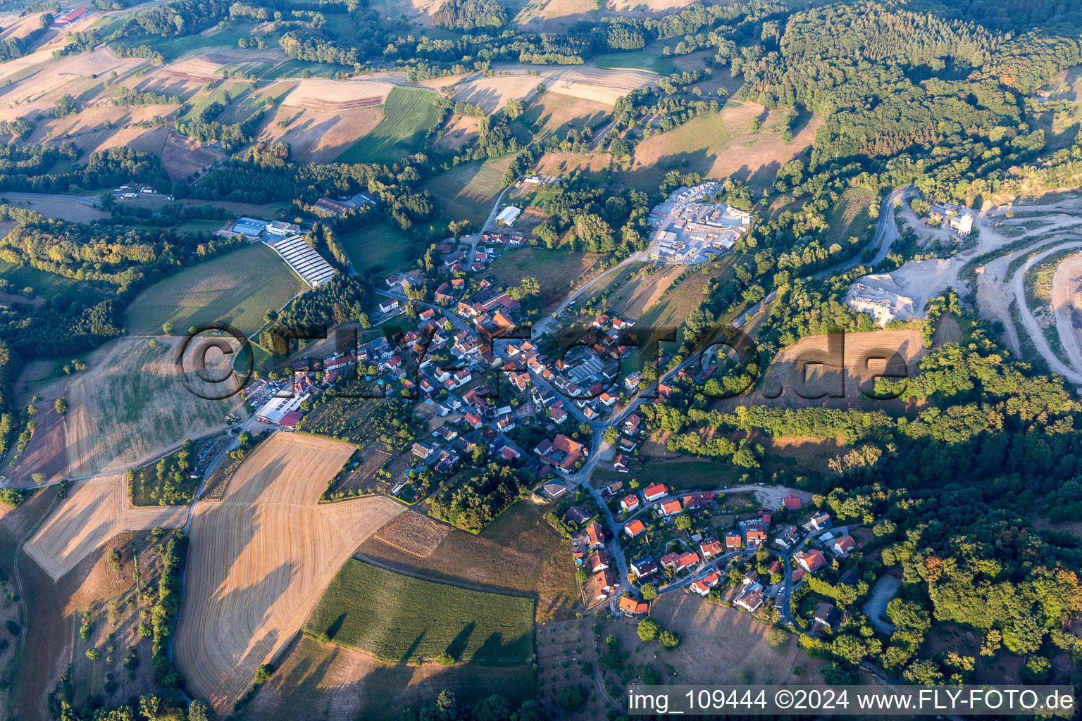 Agricultural land and field borders surround the settlement area of the village in Erlenbach in the state Hesse, Germany