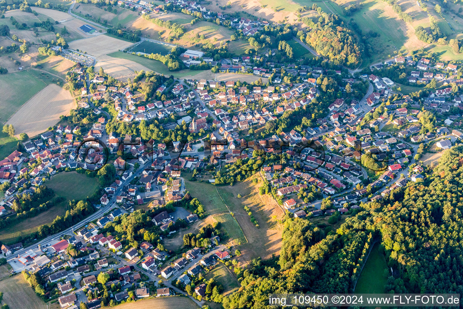 Agricultural land and field borders surround the settlement area of the village in Kirschhausen in the state Hesse, Germany from above