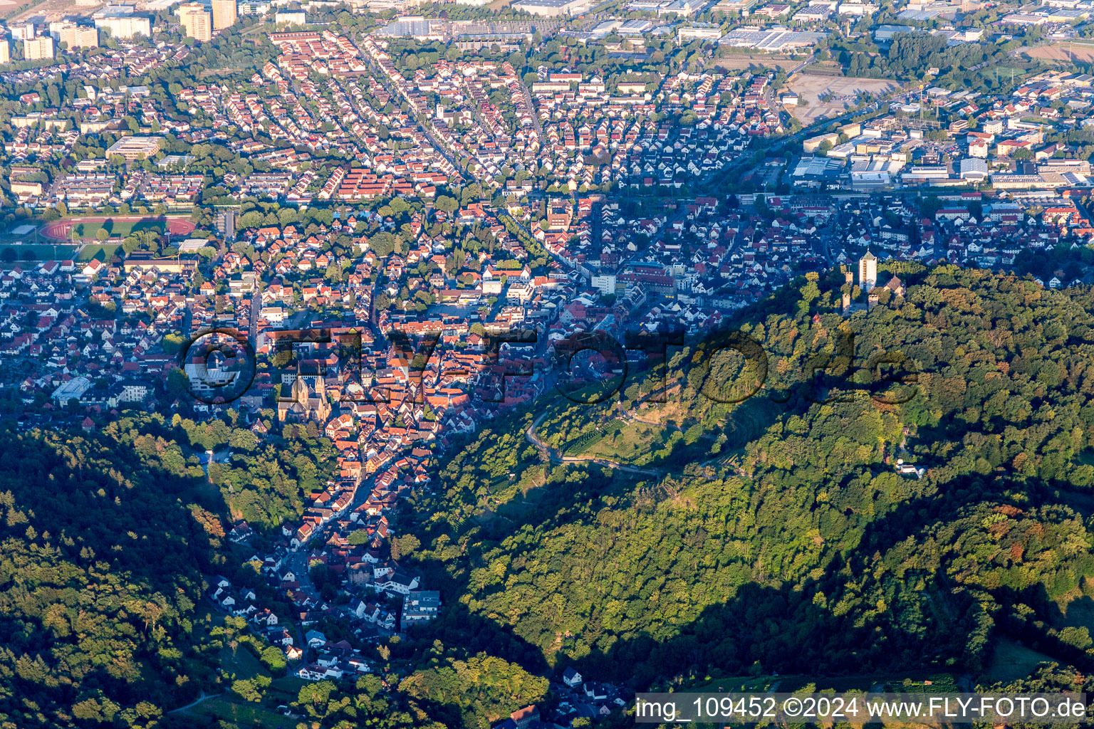 Location view of the streets and houses of residential areas in the valley landscape surrounded by mountains in Heppenheim (Bergstrasse) in the state Hesse, Germany