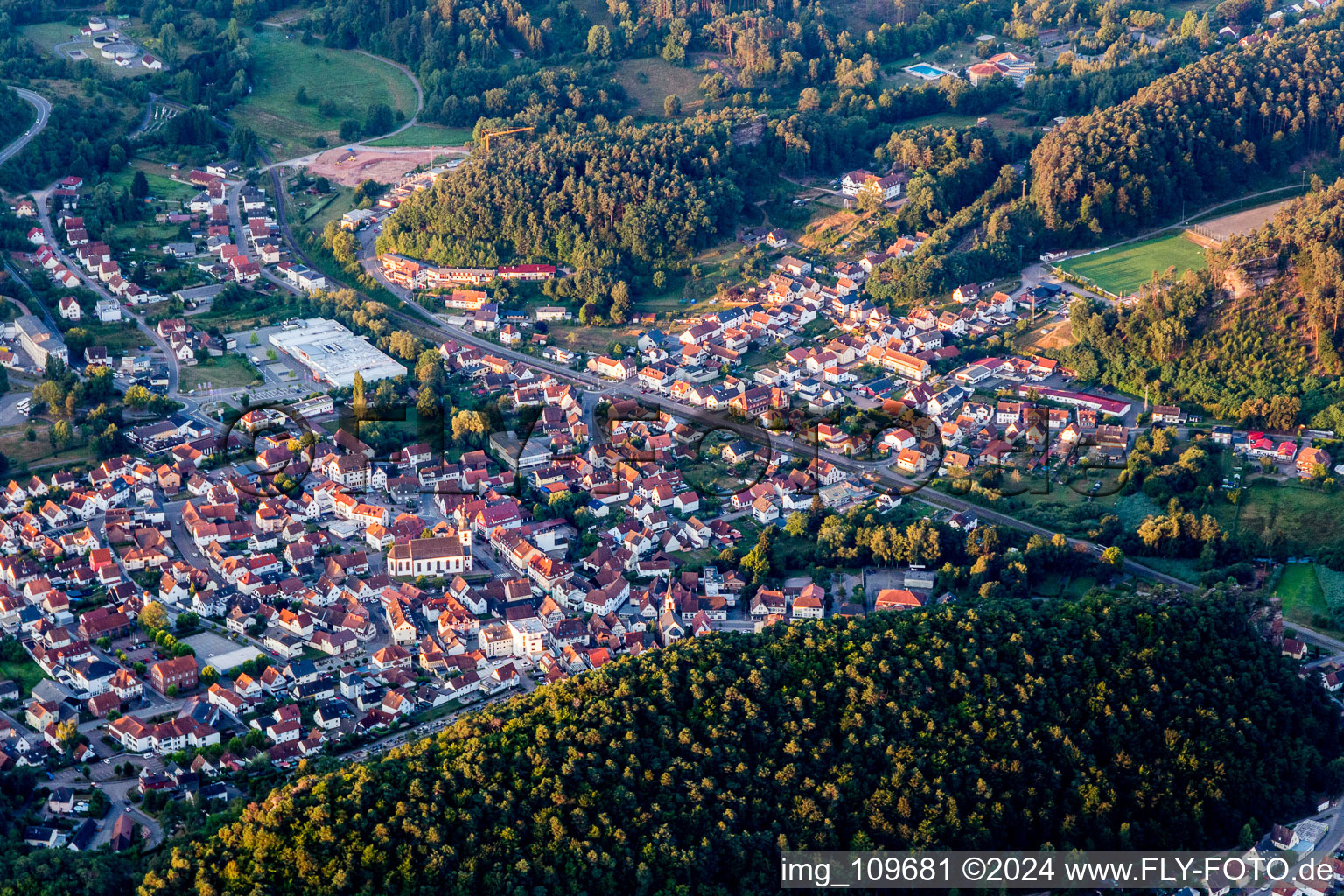 Location view of the streets and houses of residential areas in the valley landscape surrounded by mountains in Dahn in the state Rhineland-Palatinate, Germany