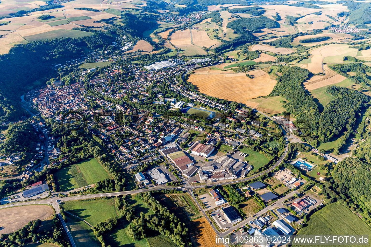 Aerial view of Location view of the streets and houses of residential areas in the Glan valley landscape surrounded by hills in Meisenheim in the state Rhineland-Palatinate, Germany