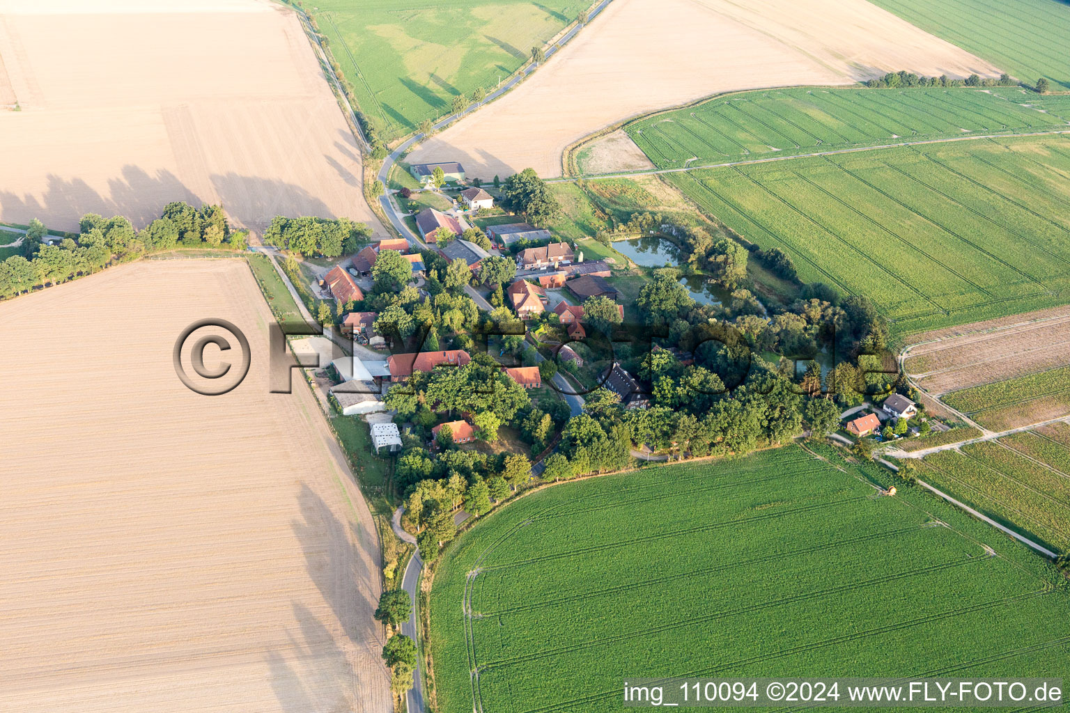 Agricultural land and field borders surround the settlement area of the village in Addenstorf in the state Lower Saxony, Germany