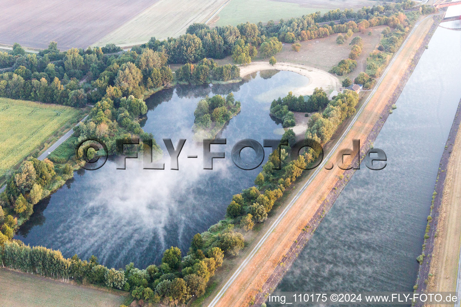 Island lake in the morning haze on the Elbe side canal at Scharnebeck in Scharnebeck in the state Lower Saxony, Germany