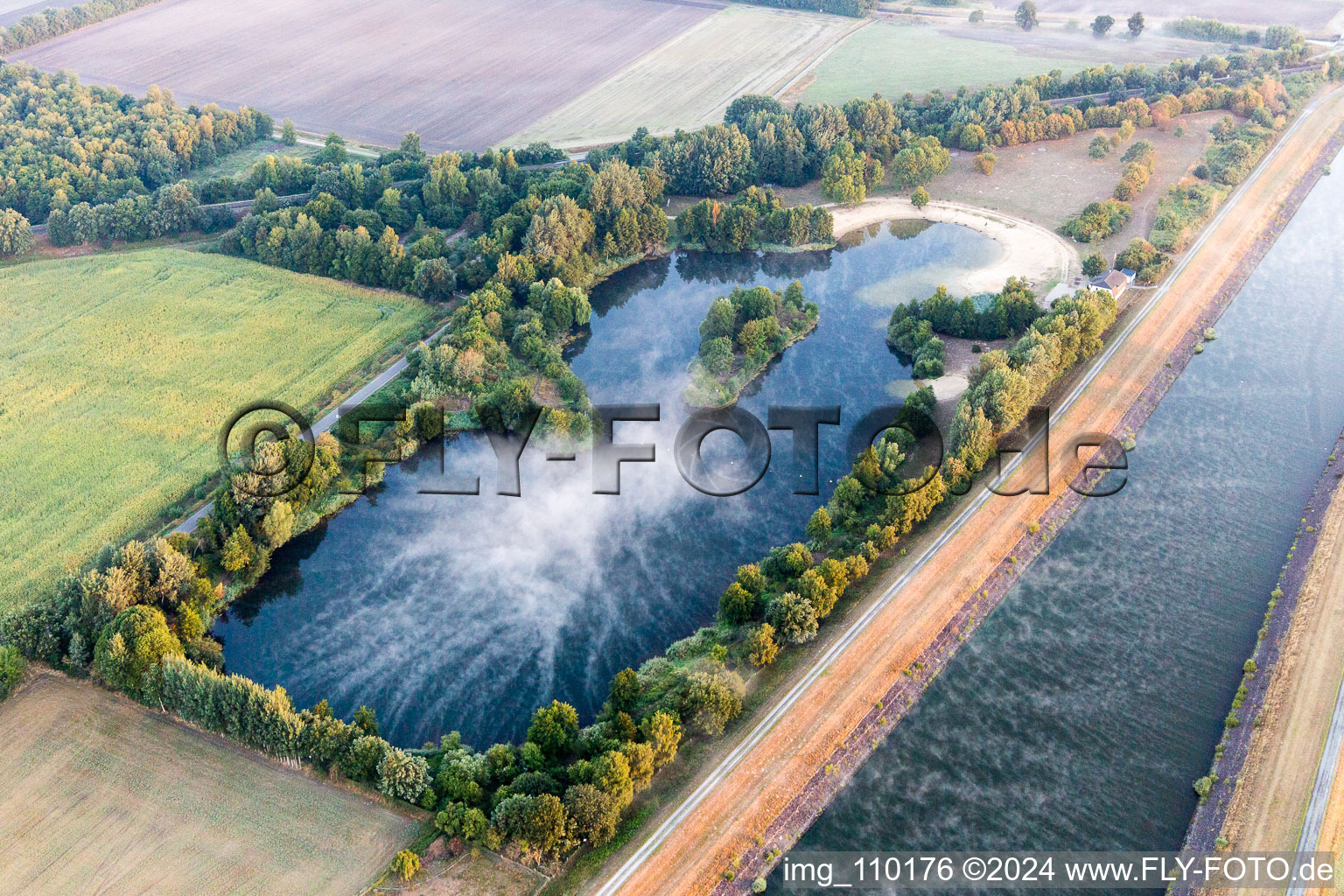Aerial view of Island lake in the morning haze on the Elbe side canal at Scharnebeck in Scharnebeck in the state Lower Saxony, Germany