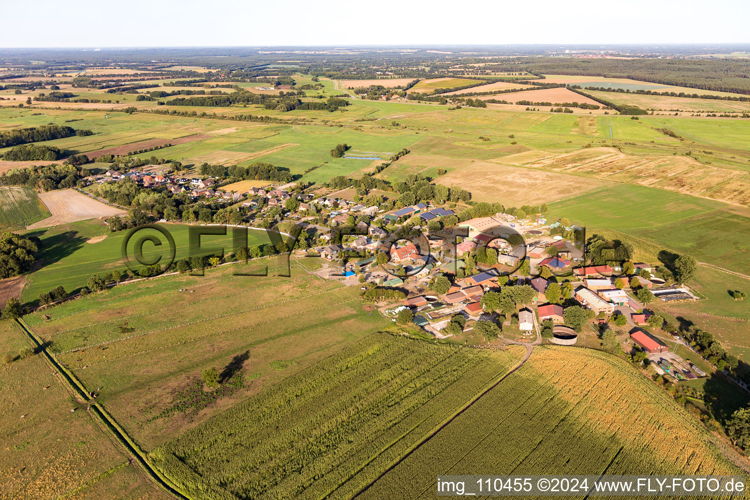 Agricultural land and field borders surround the settlement area of the village in Lanze in the state Schleswig-Holstein, Germany