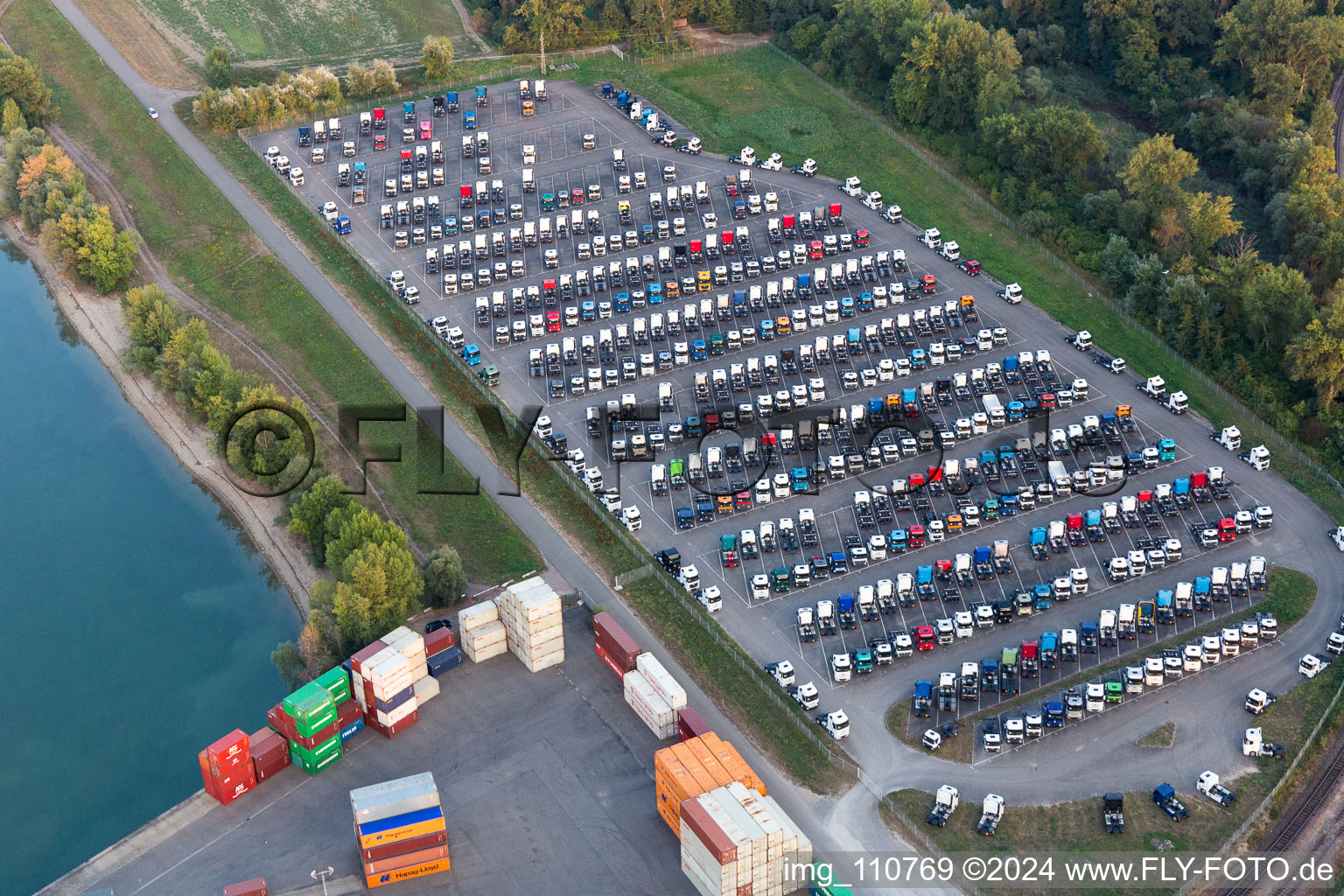 Oblique view of Truck storage on the Rhine in the district Maximiliansau in Wörth am Rhein in the state Rhineland-Palatinate, Germany