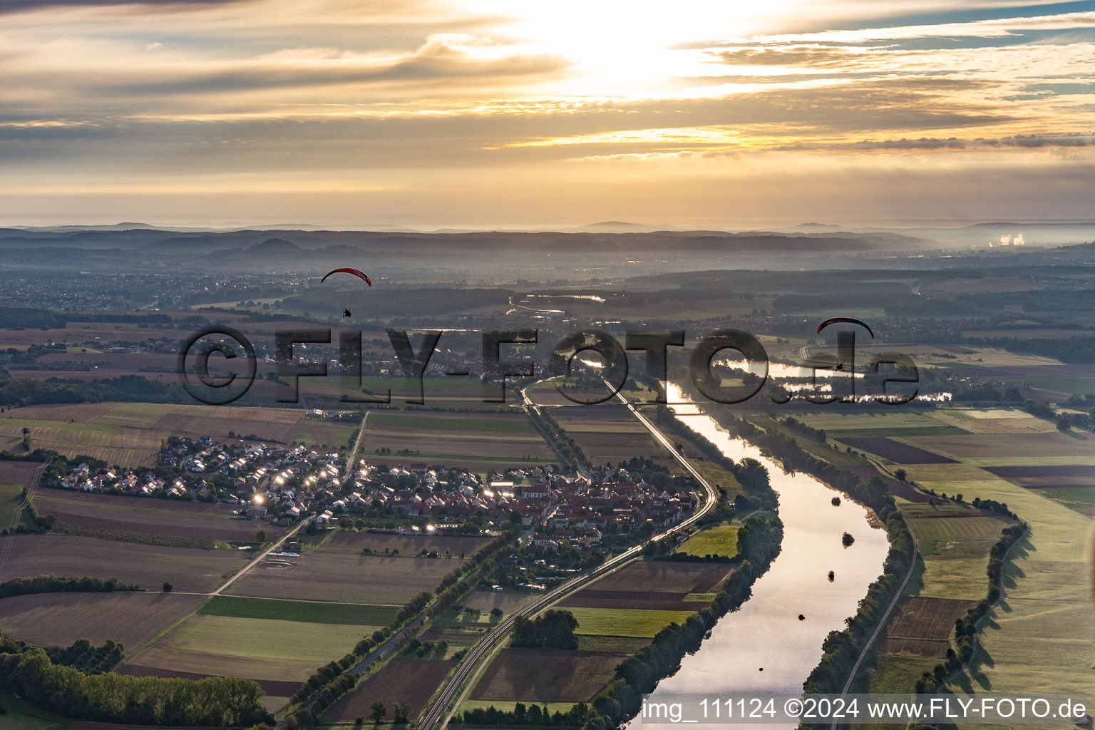 Two paragliders at sunrise over the Main in the district Untertheres in Theres in the state Bavaria, Germany