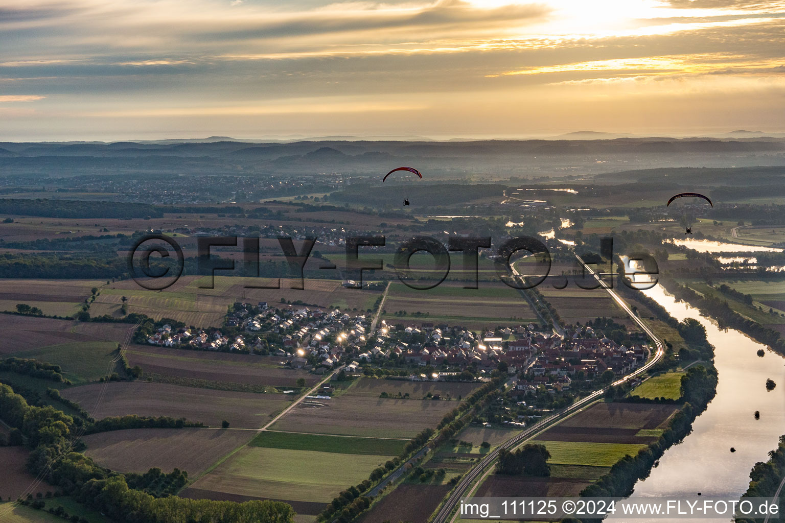 Aerial view of Two paragliders at sunrise over the Main in the district Untertheres in Theres in the state Bavaria, Germany