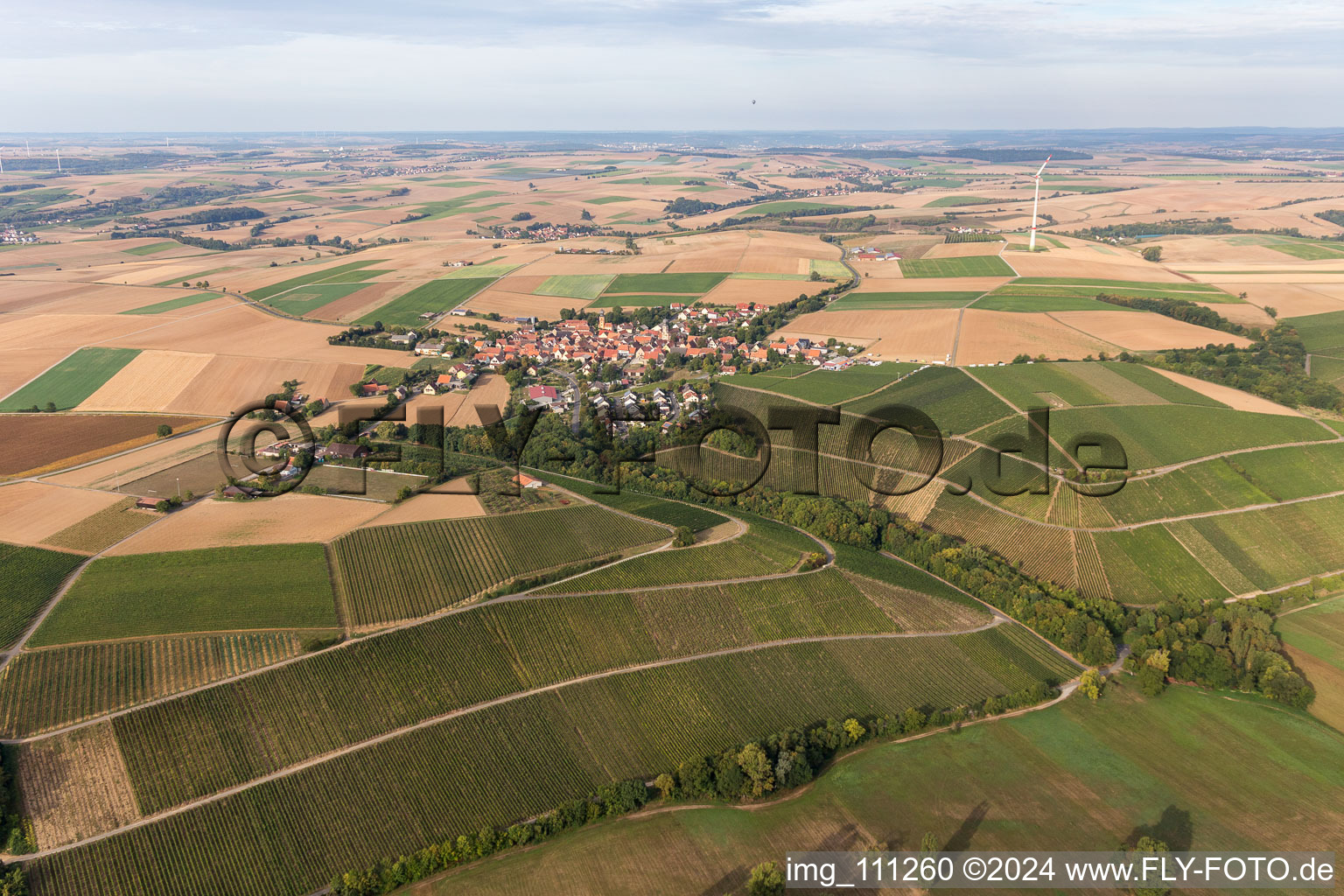 Agricultural land and field borders surround the settlement area of the village in Neuses a.Berg in the state Bavaria, Germany