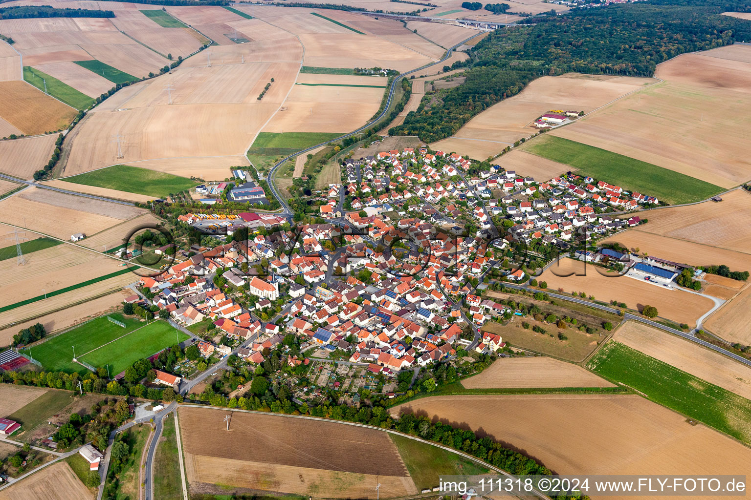 Agricultural land and field borders surround the settlement area of the village in Zeuzleben in the state Bavaria, Germany