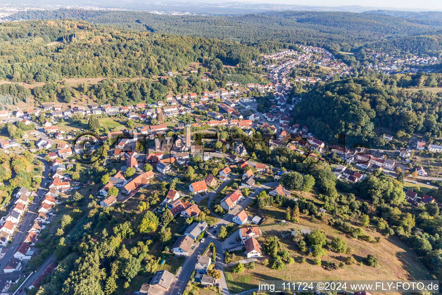 Location view of the streets and houses of residential areas in the valley landscape surrounded by mountains in Kirrberg in the state Saarland, Germany