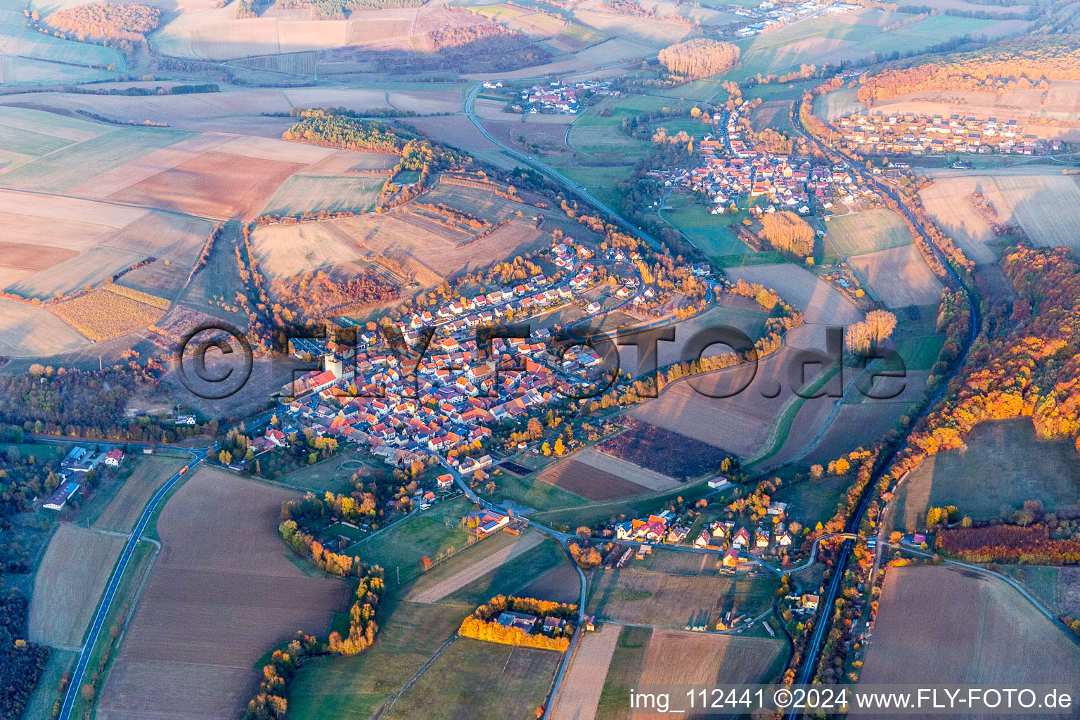 Agricultural land and field borders surround the settlement area of the village in Halsheim in the state Bavaria, Germany