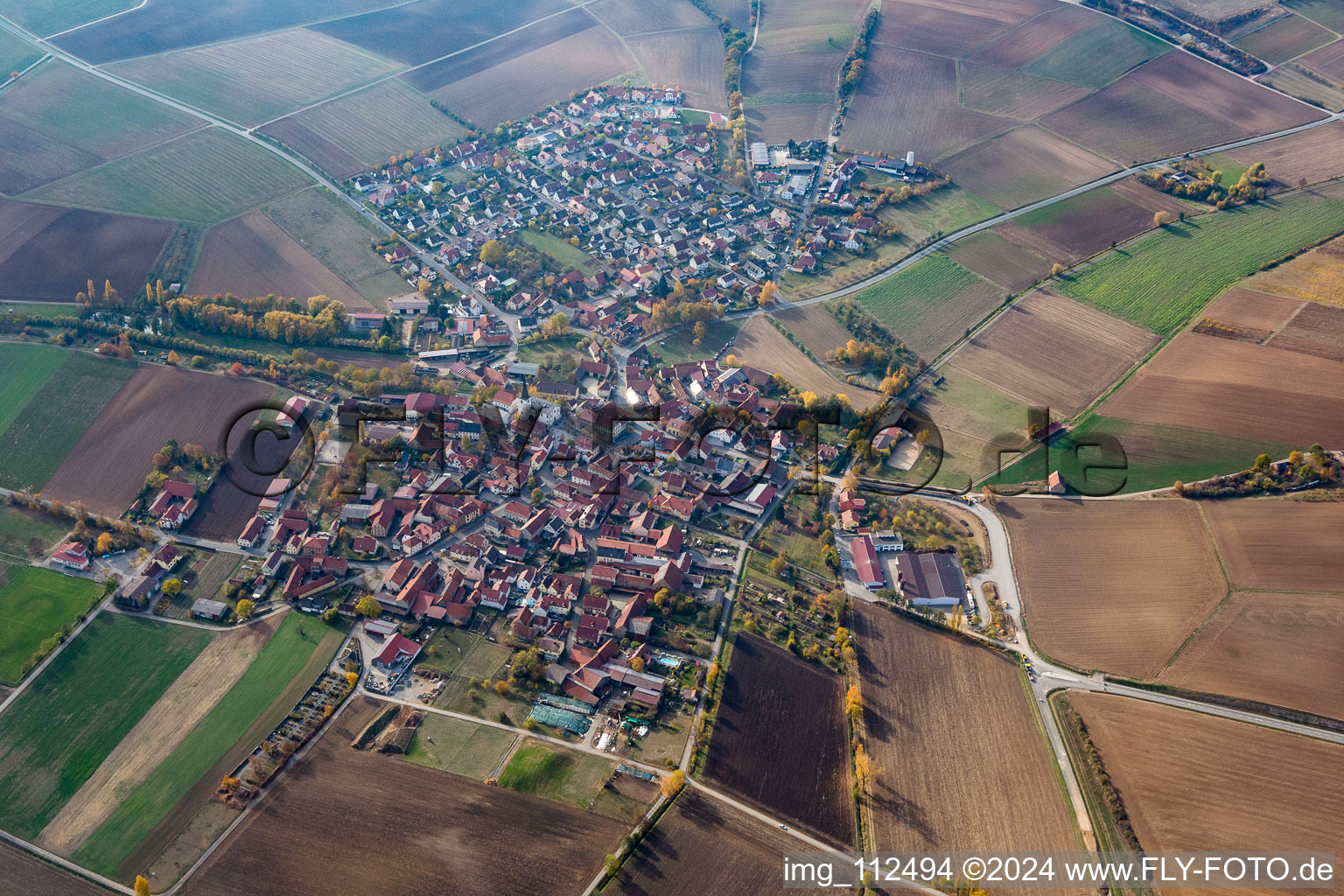 Agricultural land and field borders surround the settlement area of the village in Frankenwinheim in the state Bavaria, Germany