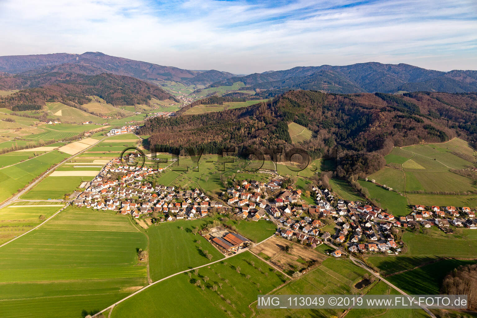 Oblique view of Agricultural land and field borders surround the settlement area of the village in Heuweiler in the state Baden-Wurttemberg, Germany