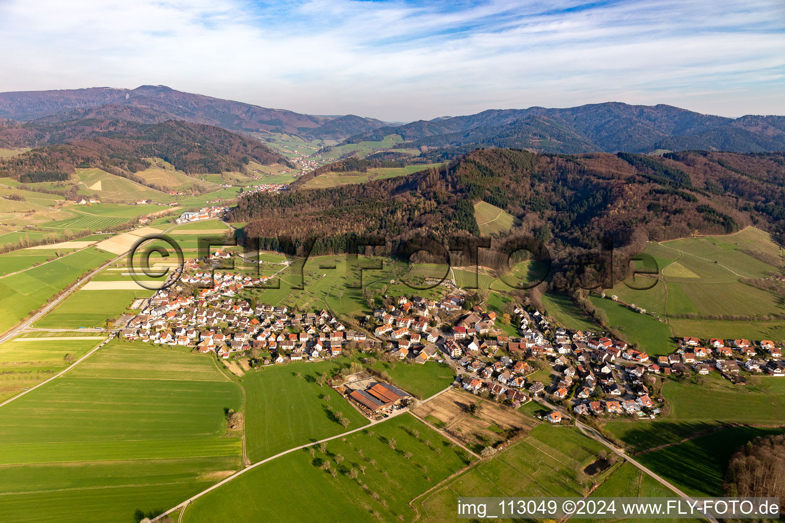 Agricultural land and field borders surround the settlement area of the village in Heuweiler in the state Baden-Wurttemberg, Germany