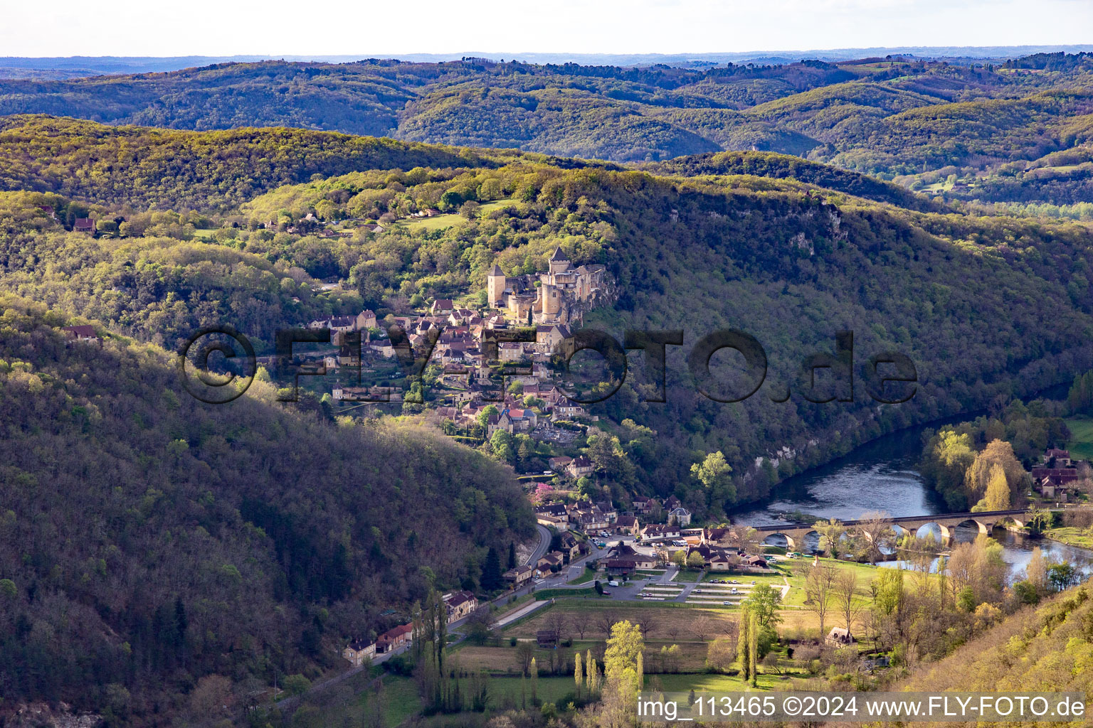 Aerial view of Chateau de Castelnaud-la Chapelle over the Dordogne Bridge in Castelnaud-la-Chapelle in the state Dordogne, France