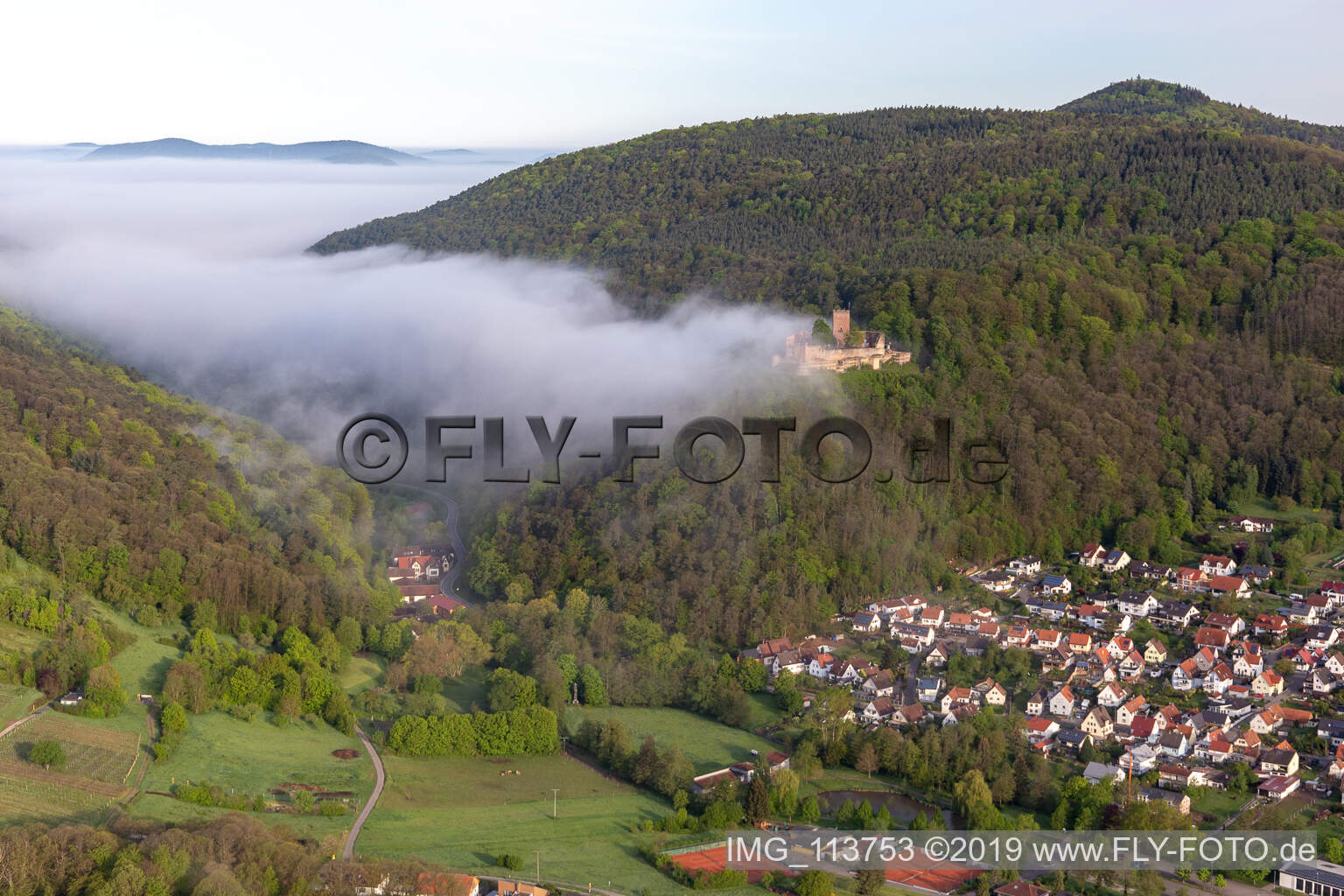 Landeck Castle in the morning fog in Klingenmünster in the state Rhineland-Palatinate, Germany from above