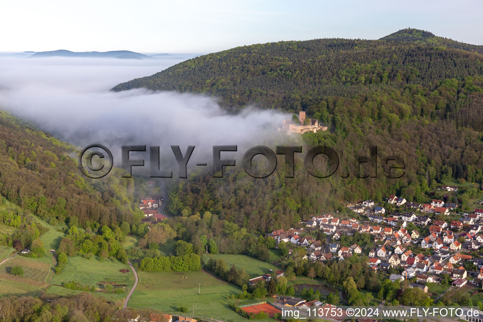 Landeck Castle in the morning fog in Klingenmünster in the state Rhineland-Palatinate, Germany from above