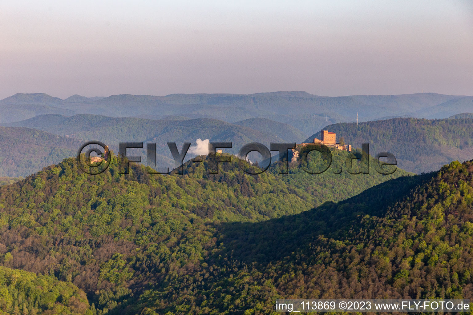 Aerial view of Castle of the fortresses Trifels, Scharfeneck and Anebos at sunset in Annweiler am Trifels in the state Rhineland-Palatinate, Germany