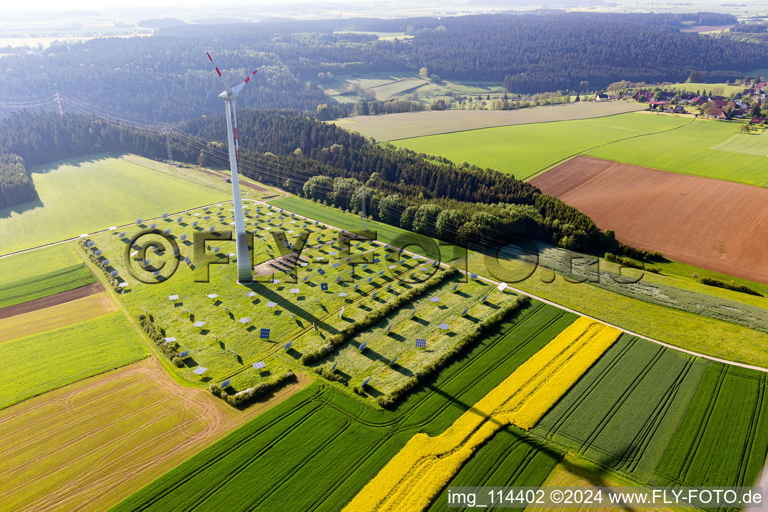 Wind turbine windmills on a solar panel field in Alpirsbach in the state Baden-Wurttemberg, Germany