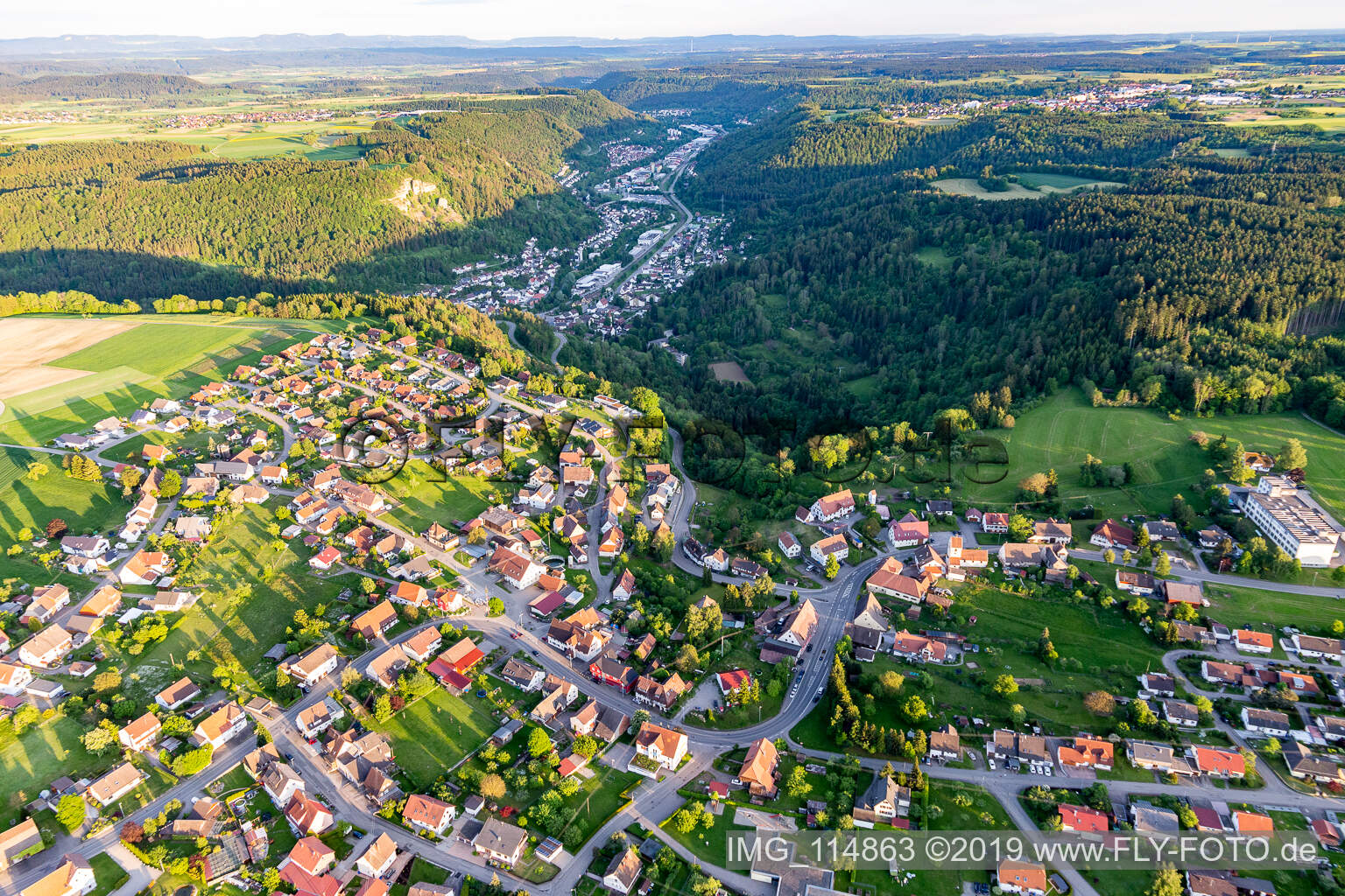 Location view of the streets and houses of residential areas in the valley landscape surrounded by mountains in Weiden in the state Baden-Wurttemberg, Germany