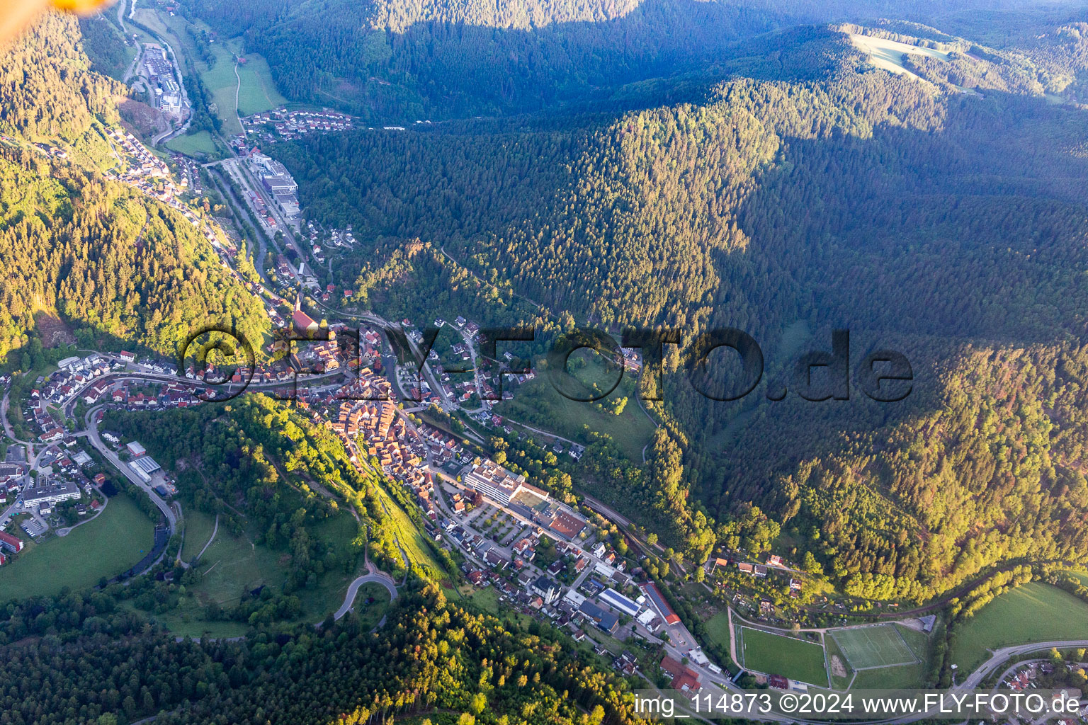 Location view of the streets and houses of residential areas in the valley landscape surrounded by mountains in Schiltach in the state Baden-Wurttemberg, Germany