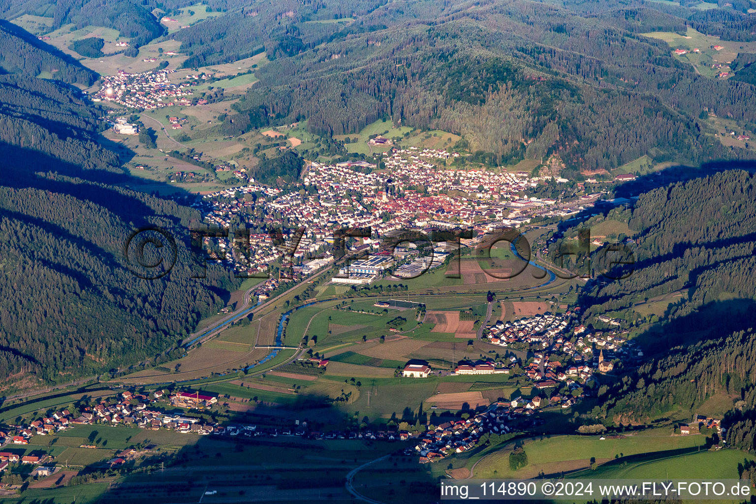 Location view of the streets and houses of residential areas in the valley landscape surrounded by mountains of the black forest in Haslach im Kinzigtal in the state Baden-Wurttemberg, Germany