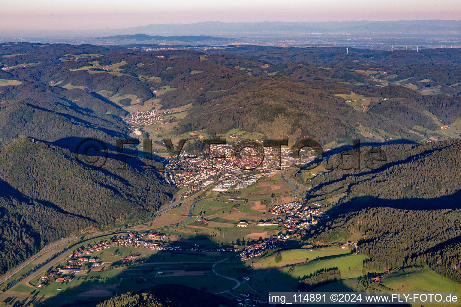 Aerial view of Location view of the streets and houses of residential areas in the valley landscape surrounded by mountains of the black forest in Haslach im Kinzigtal in the state Baden-Wurttemberg, Germany