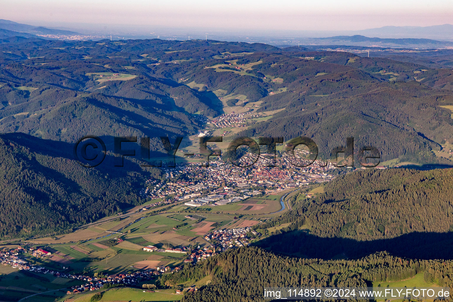 Aerial photograpy of Location view of the streets and houses of residential areas in the valley landscape surrounded by mountains of the black forest in Haslach im Kinzigtal in the state Baden-Wurttemberg, Germany