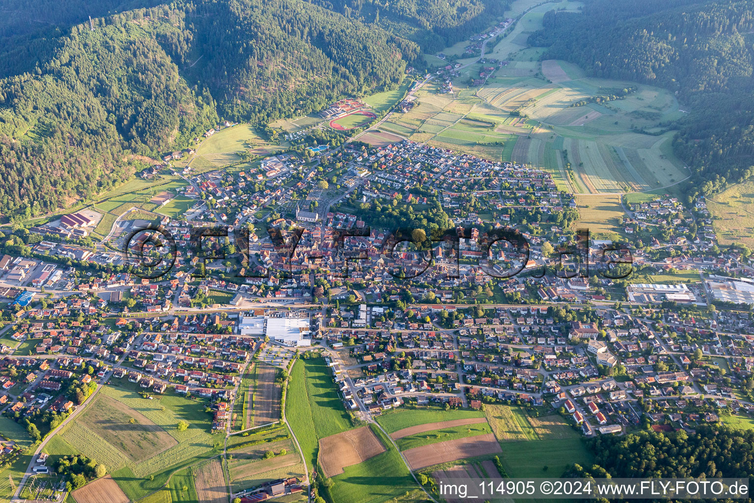 Location view of the streets and houses of residential areas in the valley landscape surrounded by mountains of the Black Forest in Zell am Harmersbach in the state Baden-Wurttemberg, Germany