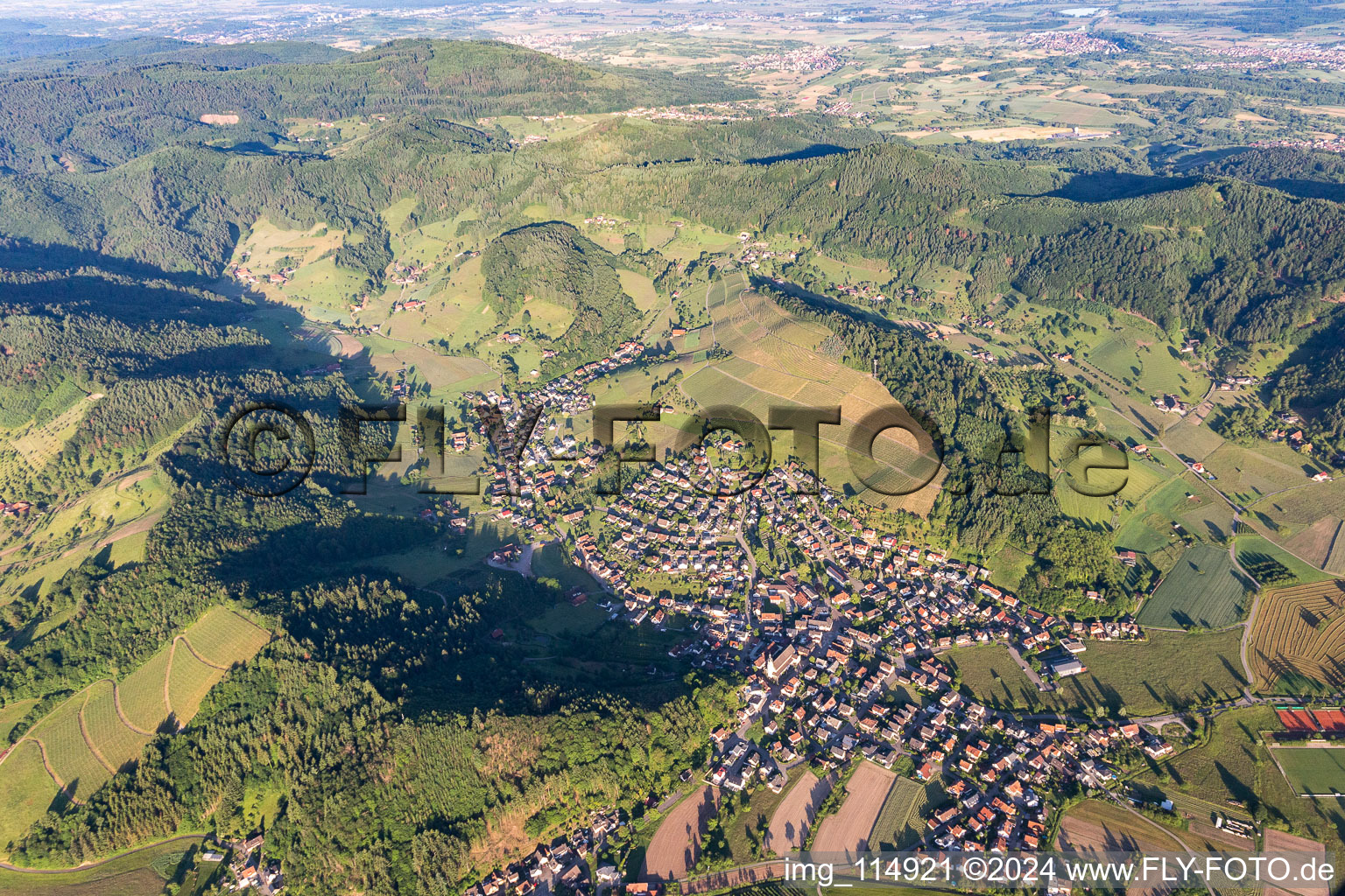 Location view of the streets and houses of residential areas in the valley landscape surrounded by mountains in Berghaupten in the state Baden-Wurttemberg, Germany