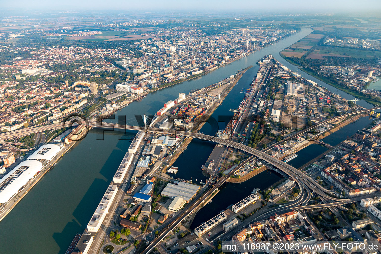 Quays and boat moorings at the port of the inland port Rhine-harbour and Kurt-Schuhmacher-bridge for the B44 crossing the Rhine to Ludwigshafen in Mannheim in the state Baden-Wurttemberg, Germany
