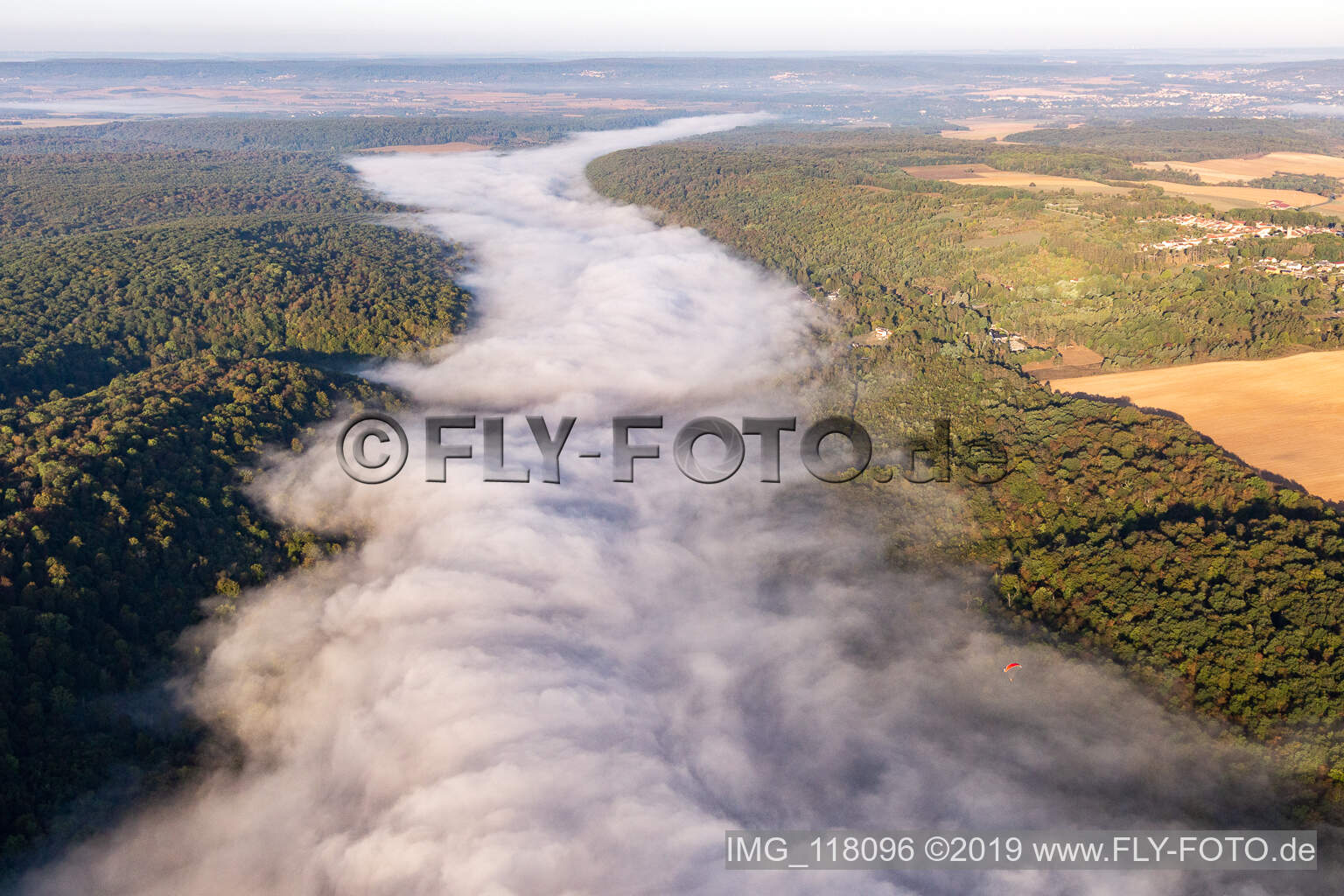 Riparian zones with fog clouds on the course of the river of the river Mosel in Maron in Grand Est, France