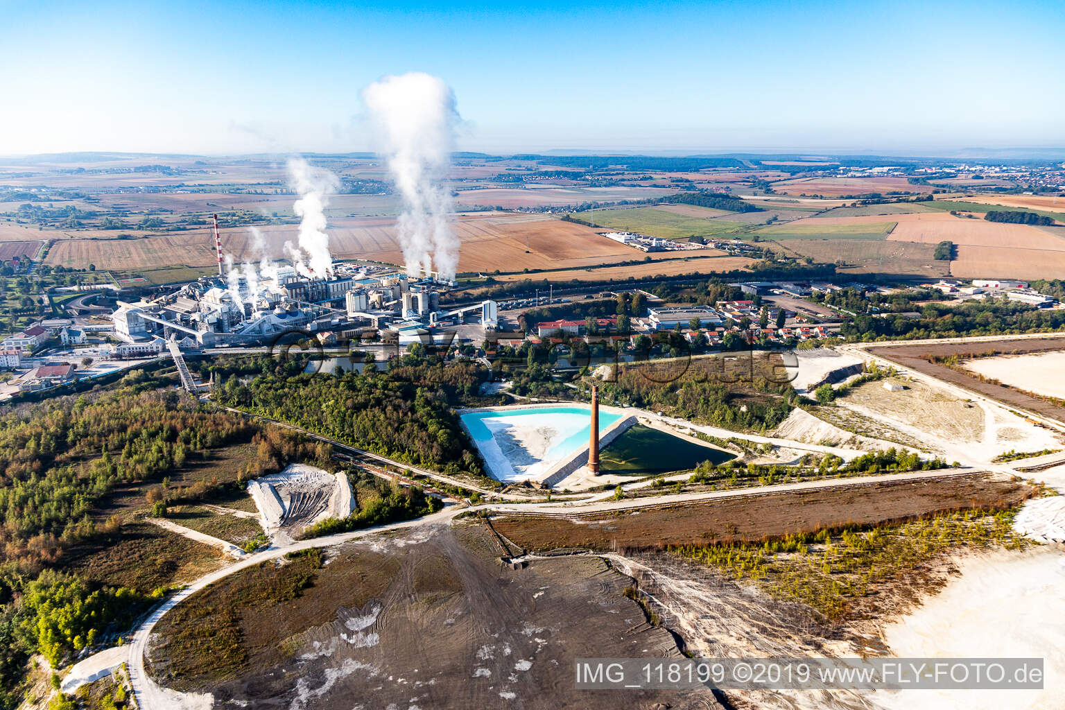 Aerial view of Turquoise-blue saltworks for the potash extraction of the Compagnie des Salins du Midi et des Salines de l'Est SA and Chemical plant SEQENS La Madeleine (Novacarb) in Laneuveville-devant-Nancy in Grand Est, France