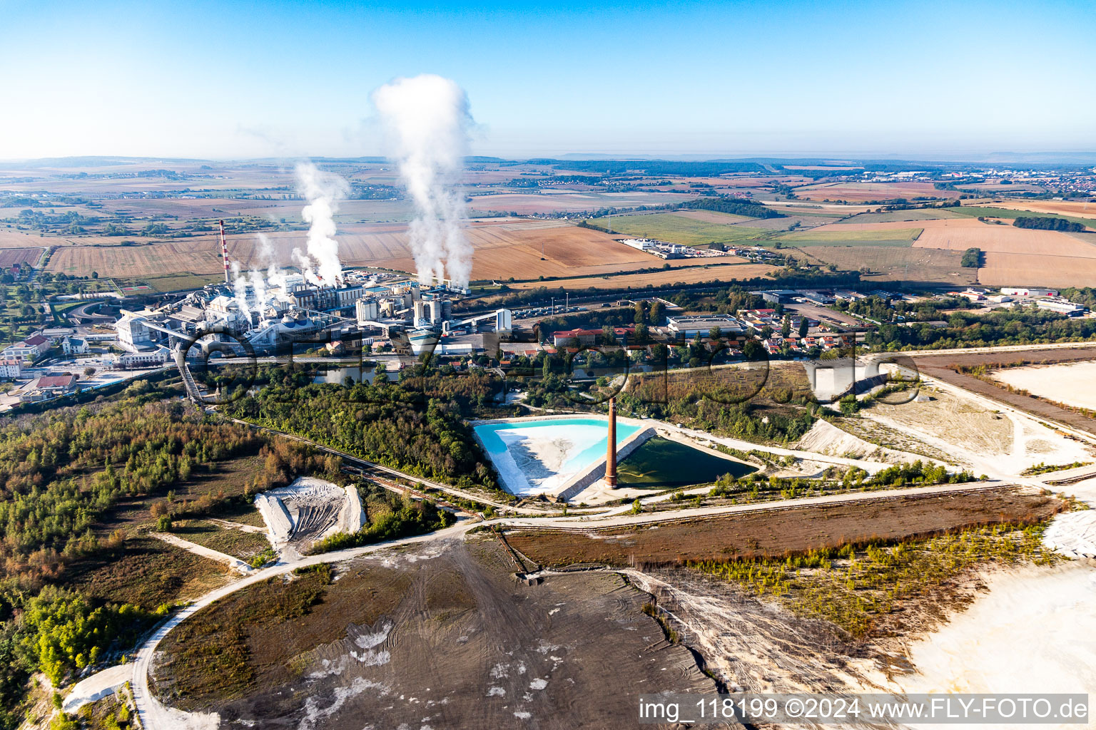 Aerial view of Turquoise-blue saltworks for the potash extraction of the Compagnie des Salins du Midi et des Salines de l'Est SA and Chemical plant SEQENS La Madeleine (Novacarb) in Laneuveville-devant-Nancy in Grand Est, France